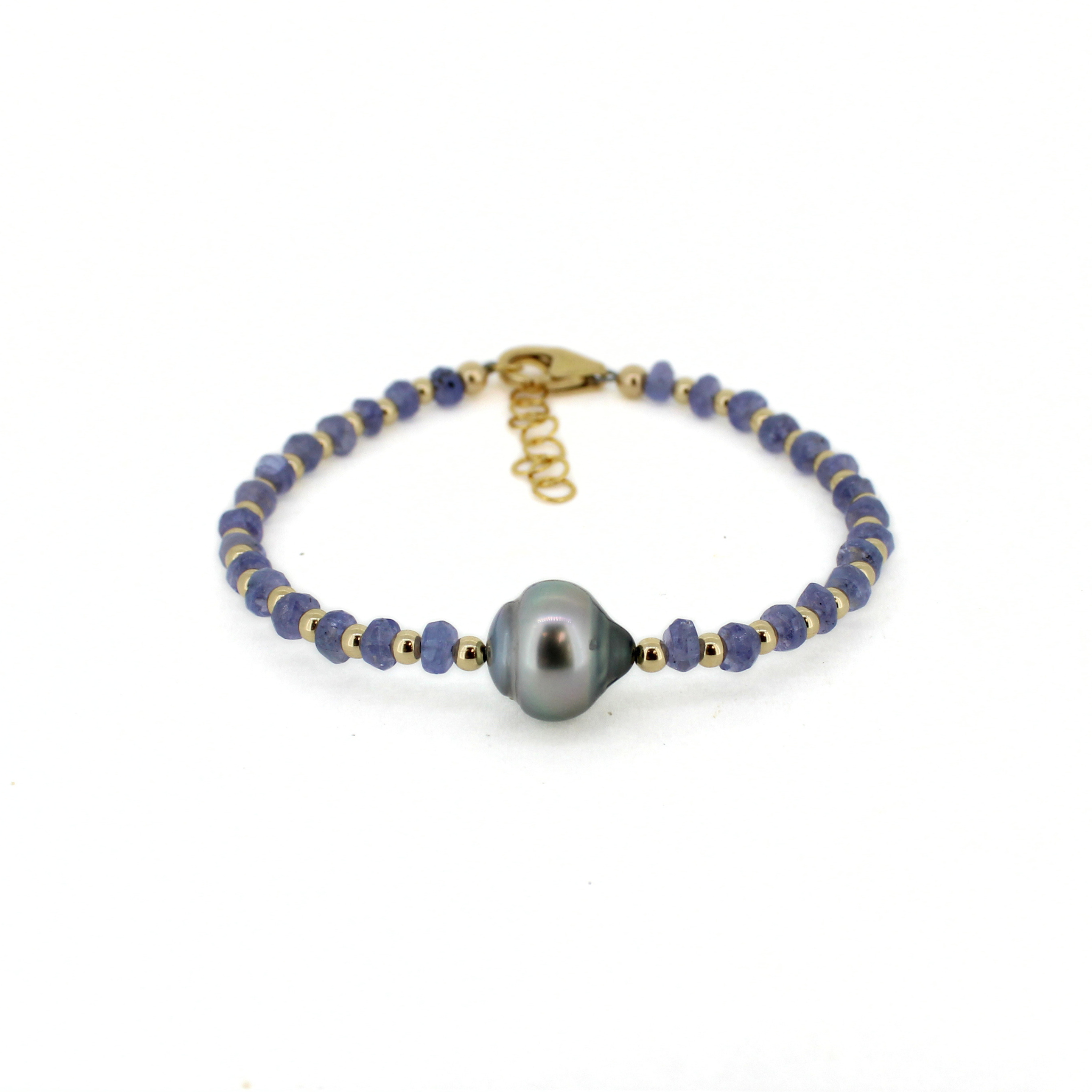 Gold clasp view: dark blue beaded bracelet with central gray baroque pearl and chain.