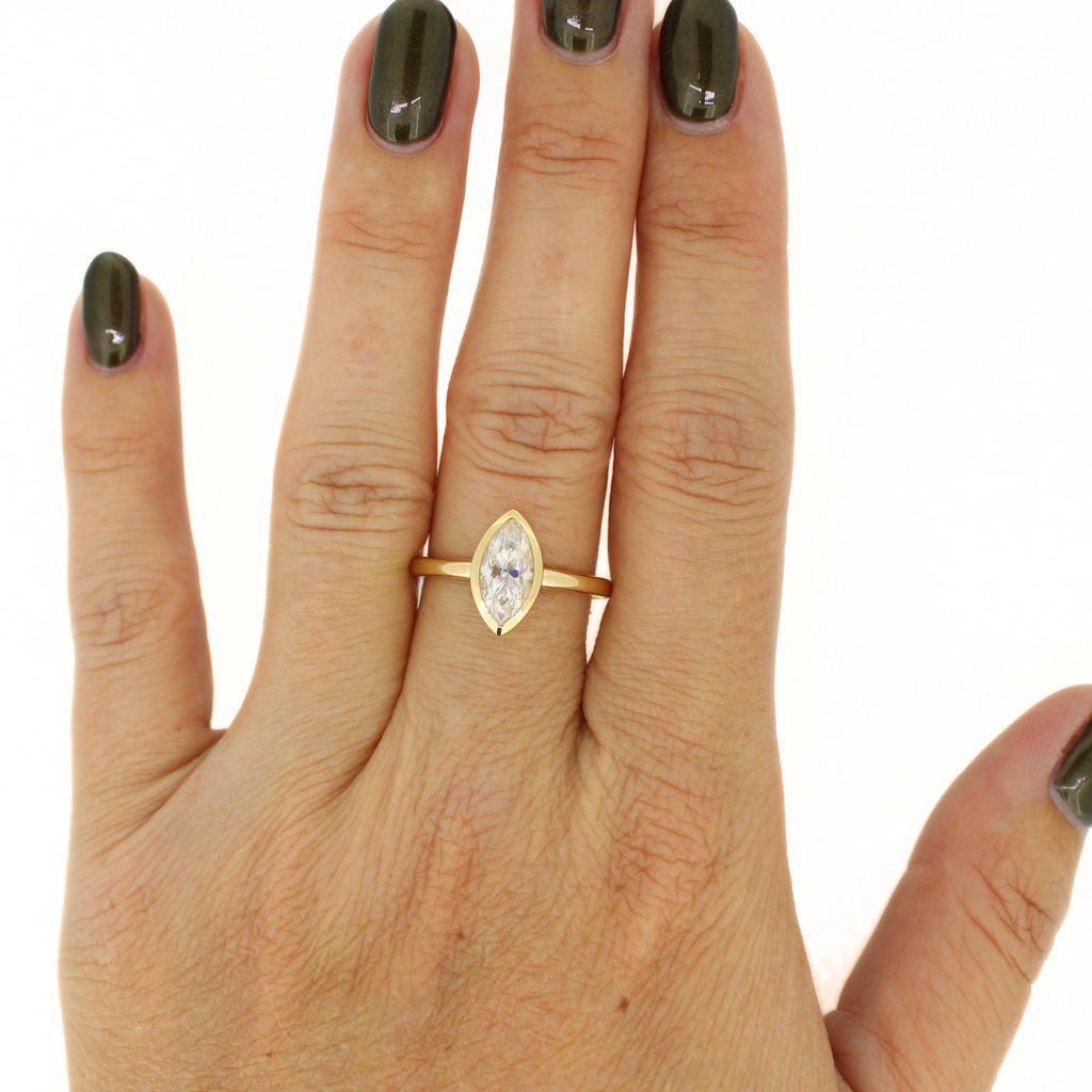 Brianne & Co. 14k gold marquise moissanite ring on model
