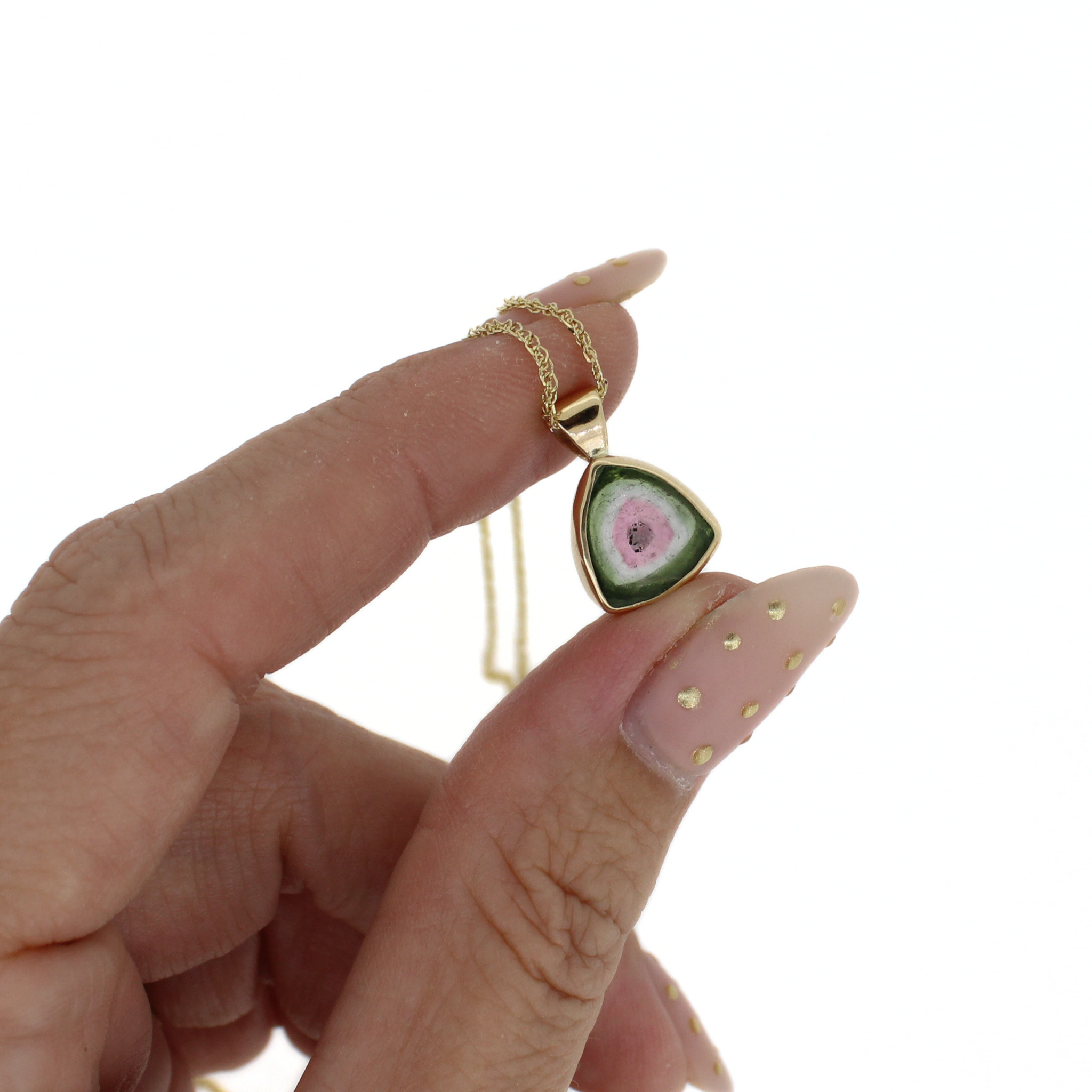 14k gold watermelon tourmaline pendant necklace held in hand, teardrop pink stone