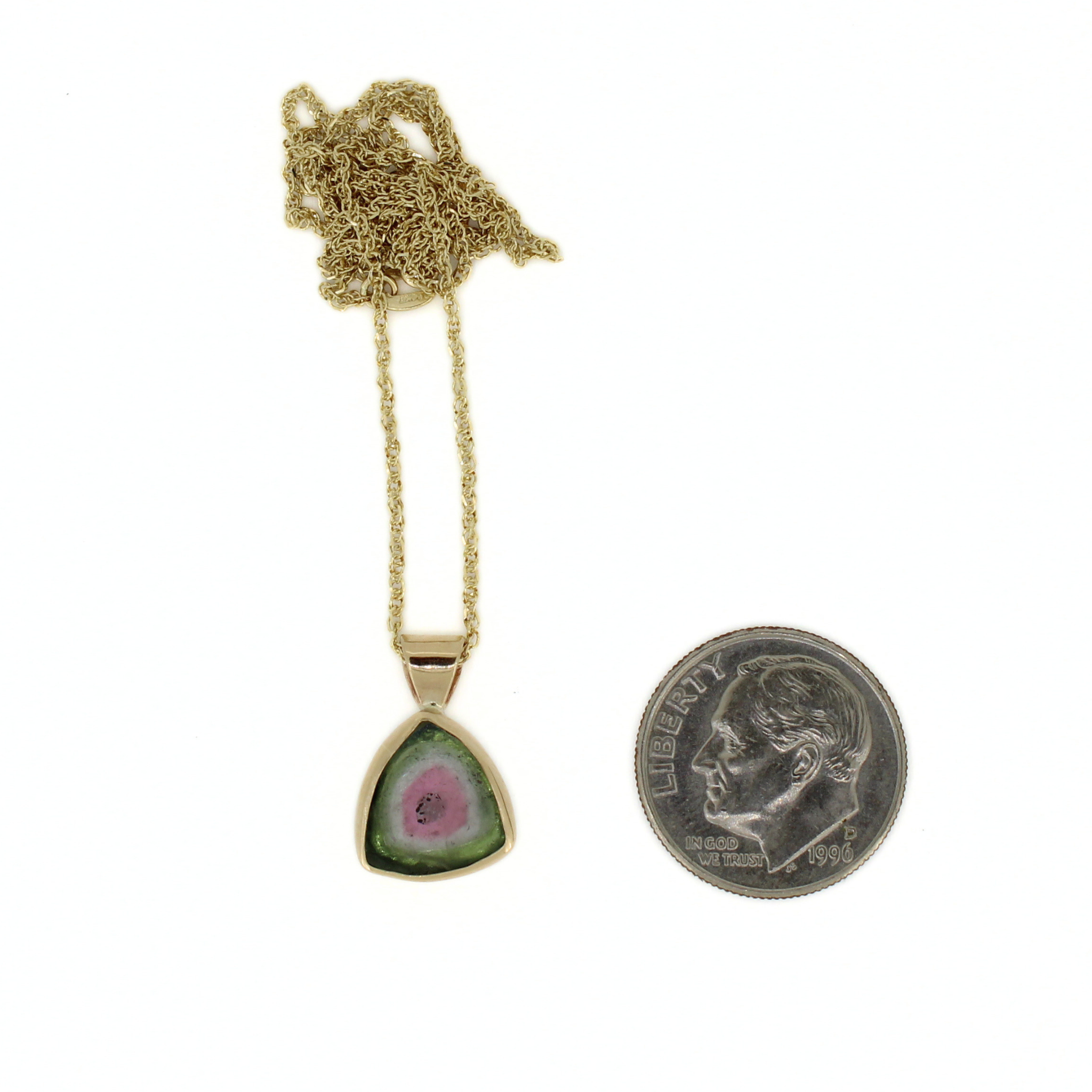 14k gold watermelon tourmaline pendant necklace beside coin for scale, teardrop stone