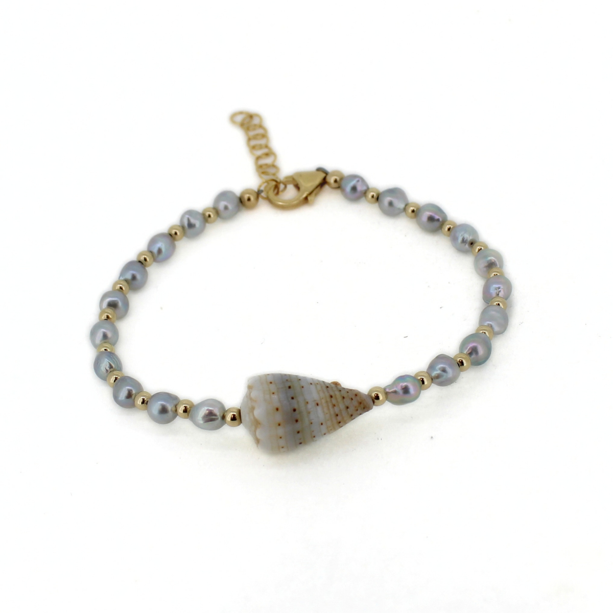 A delicate bracelet featuring light gray iridescent pearls, small gold spacer beads, a gold lobster clasp, and a central conch shell charm, displayed on a clean white background.