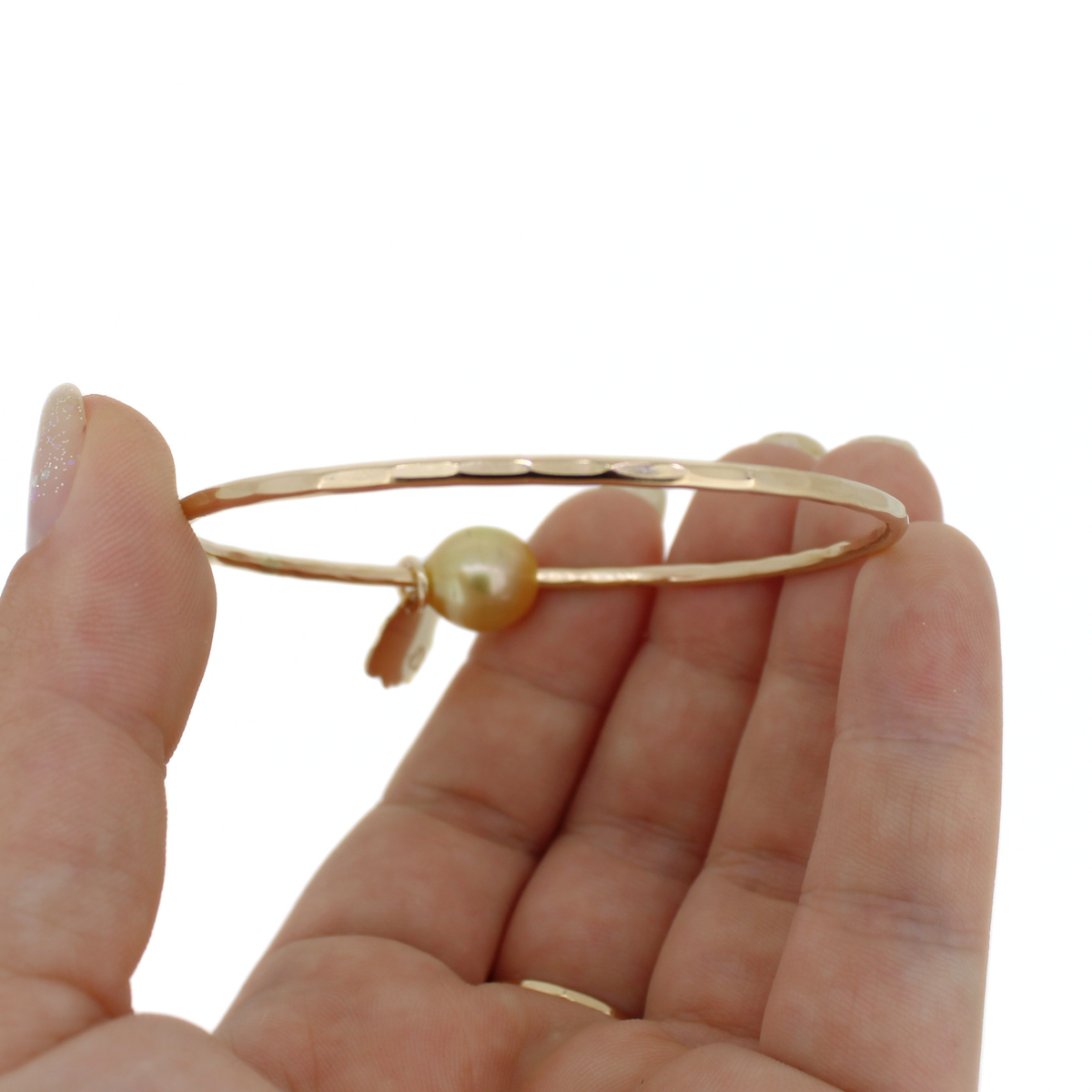Gold bangle bracelet with a hammered texture