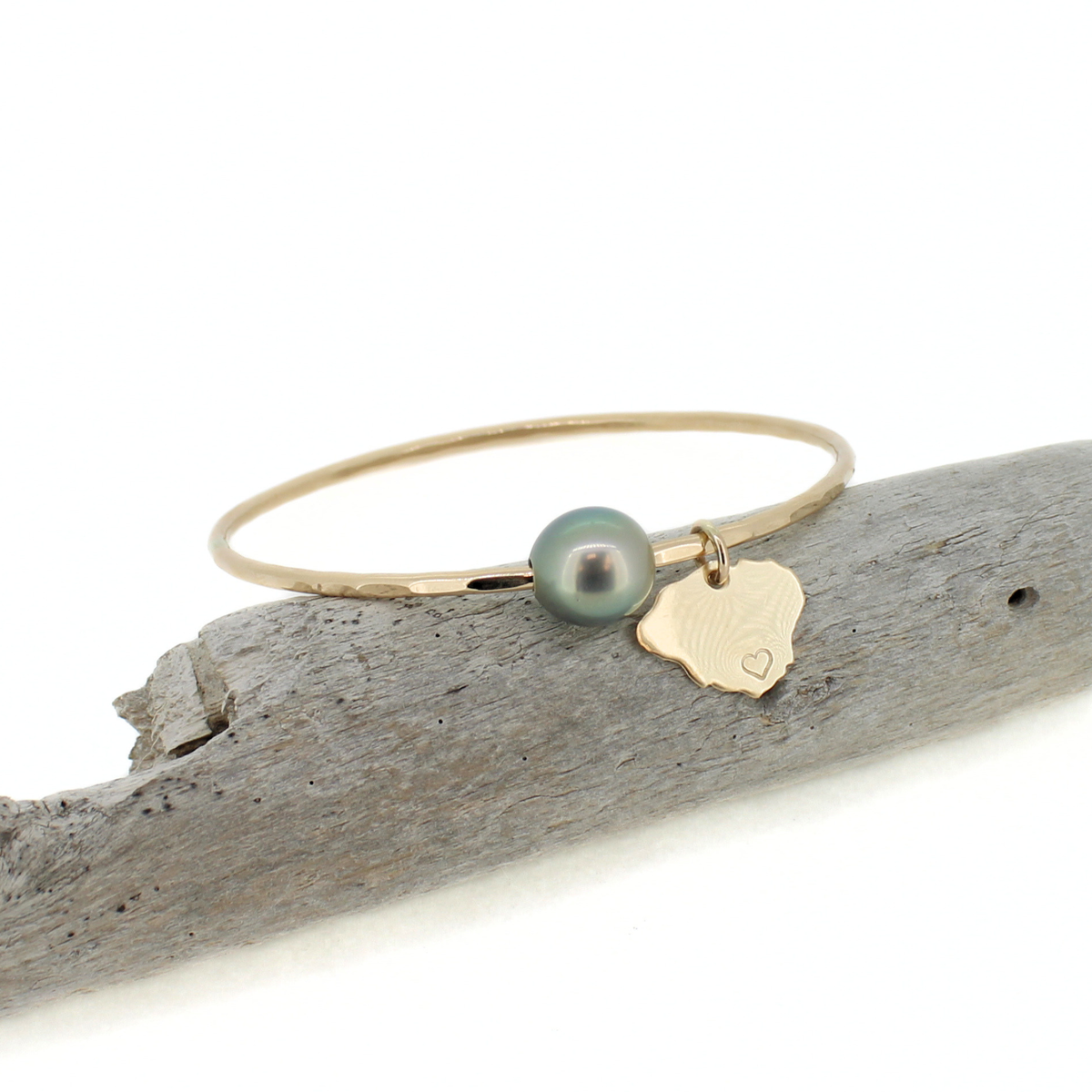 Brianne & Co. 14k gold fill bangle bracelet featuring a genuine Tahitian pearl and our Kauai island charm with a heart on the south side of the island