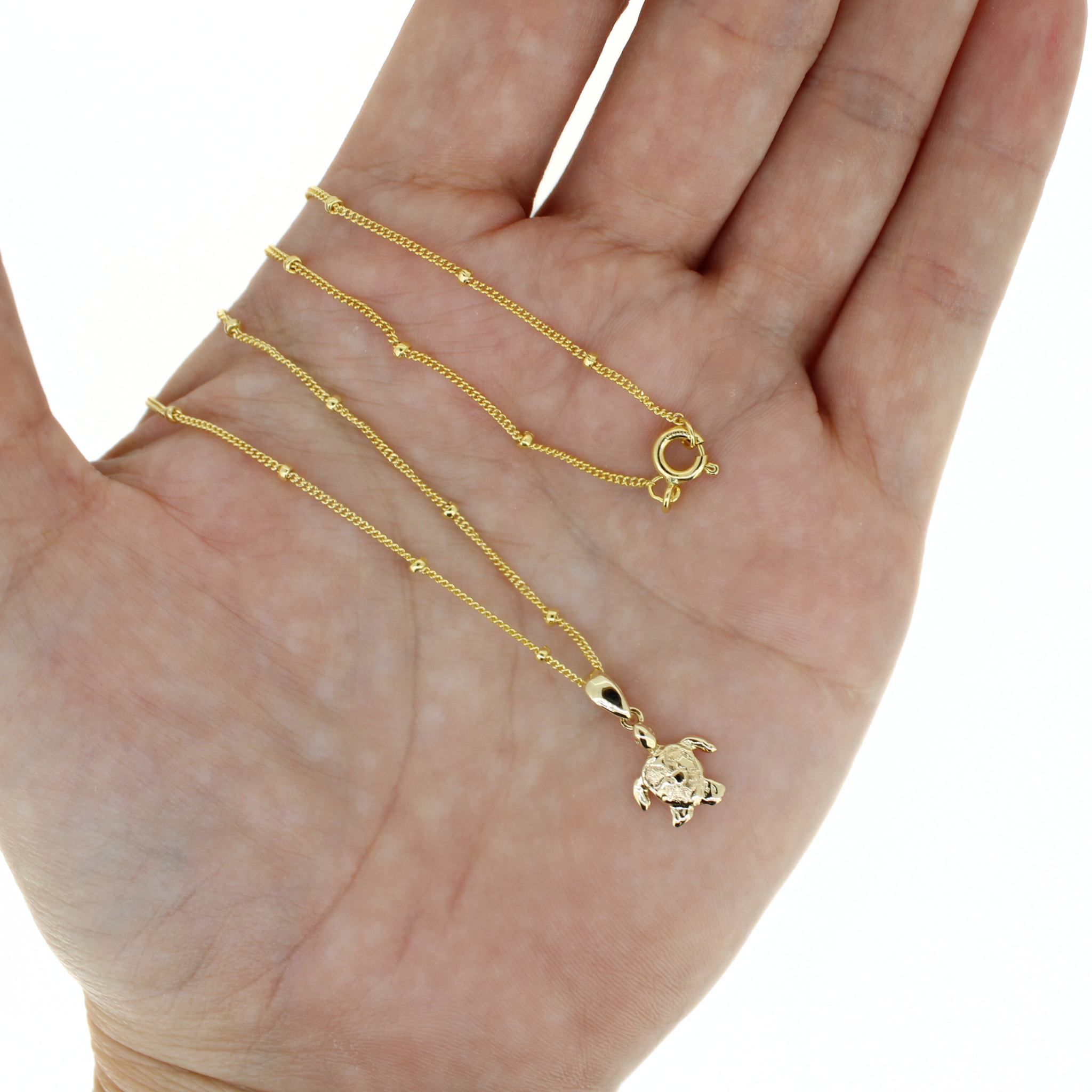 Gold mini turtle pendant necklace with thin chain and spring-ring clasp