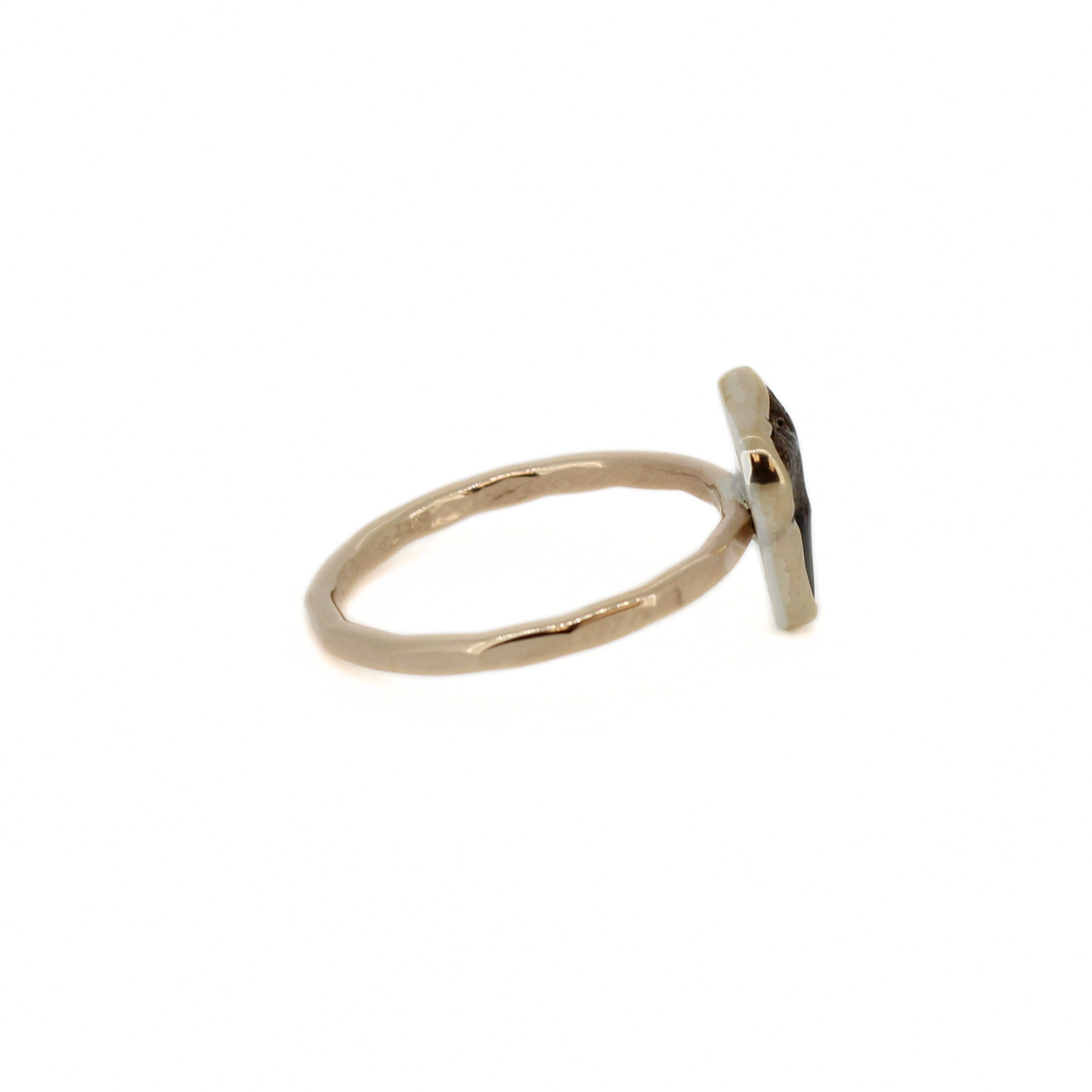Gold shark tooth ring side view with dark tooth detail