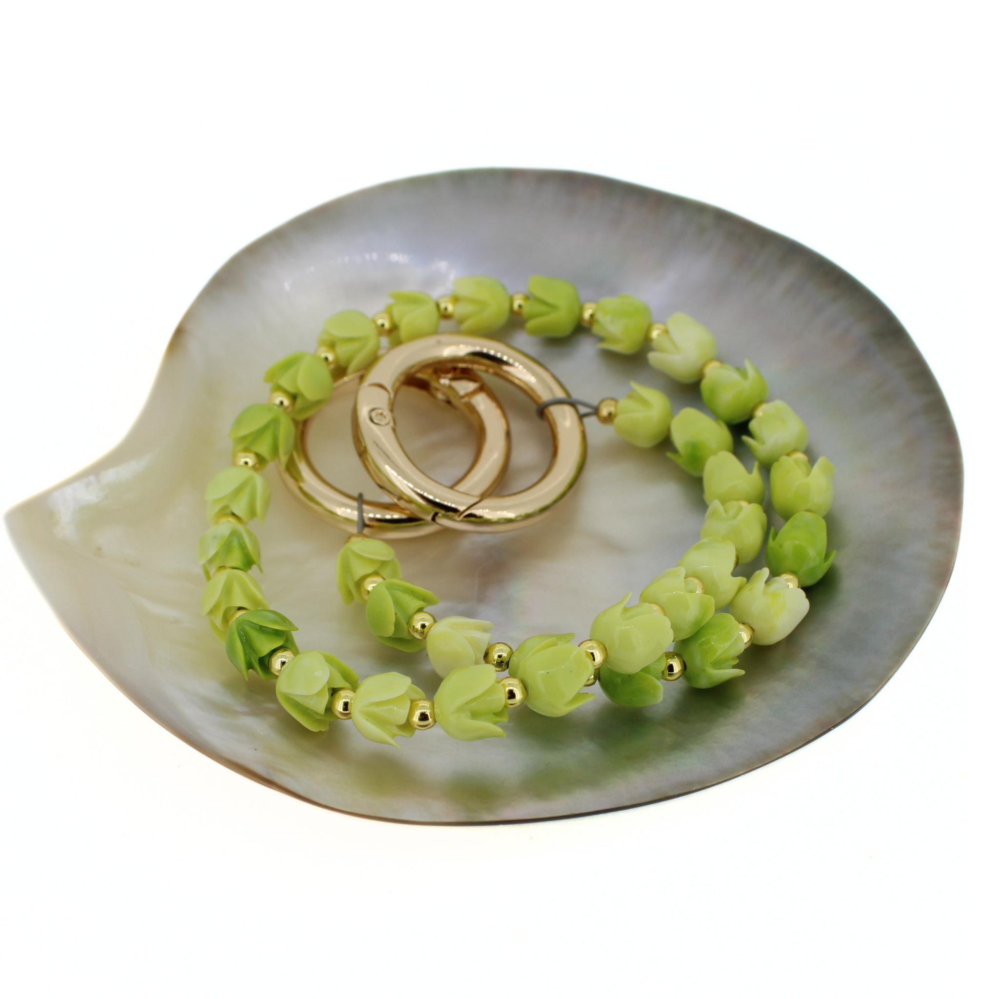 Lime green flower bead lei with gold hoop clips, laid flat