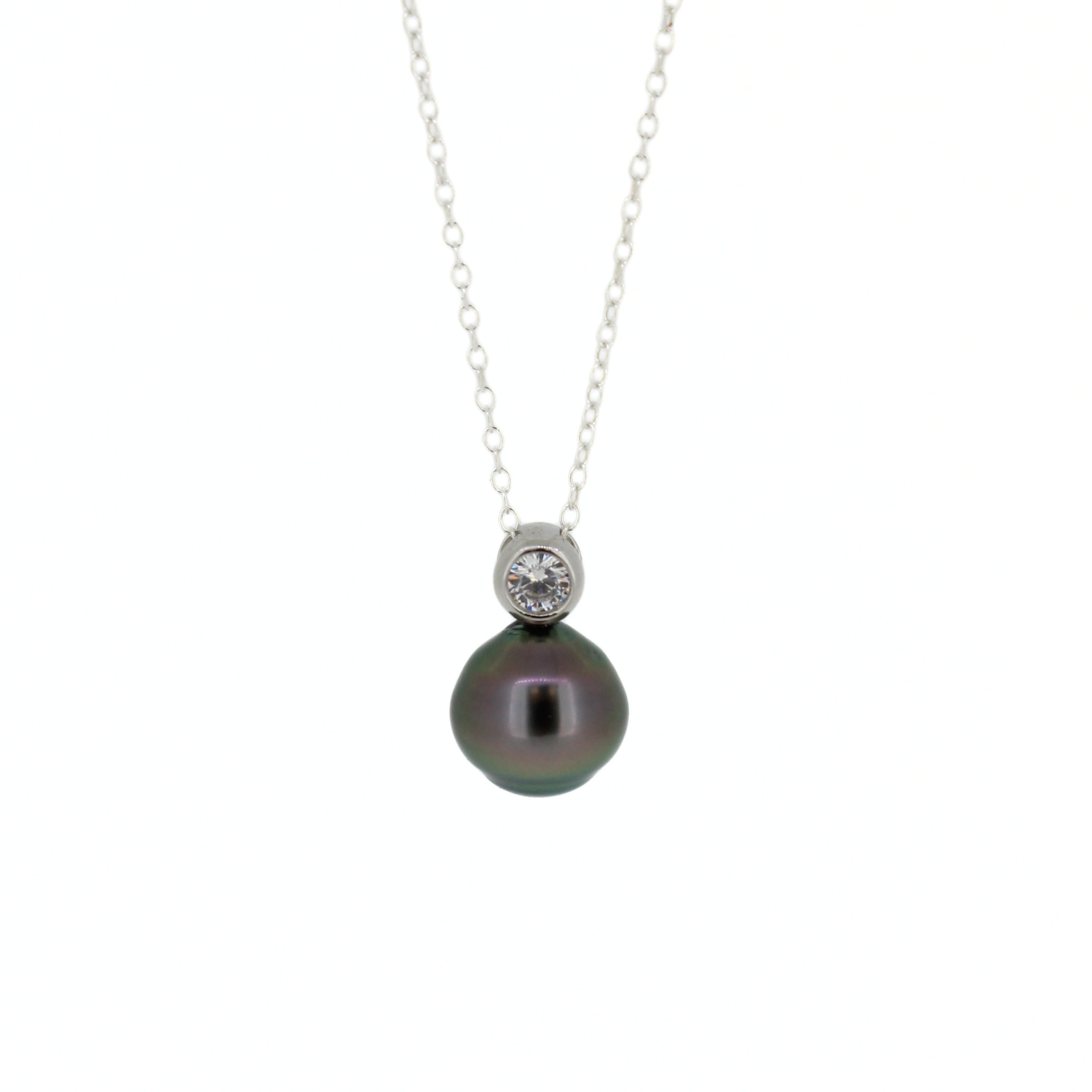 A silver pendant necklace featuring a single dark, iridescent Tahitian pearl suspended below a small bezel-set clear cubic zirconia gemstone, shown on a plain white background.