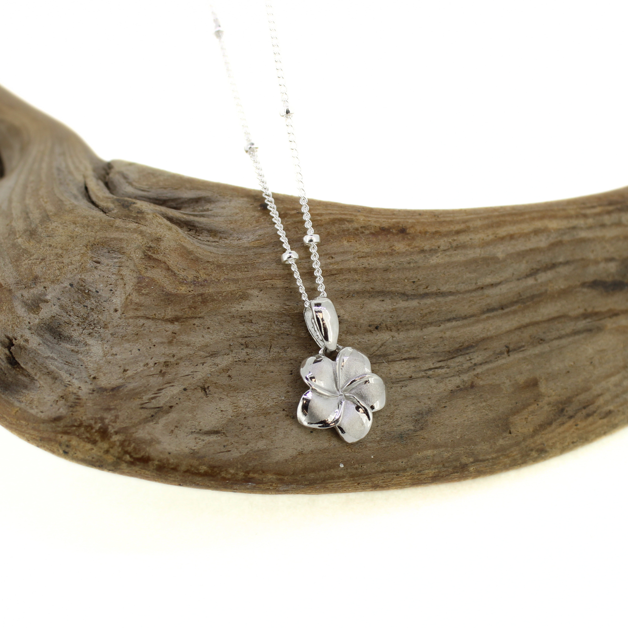 Brianne & Co. sterling silver small plumeria flower pendant close up