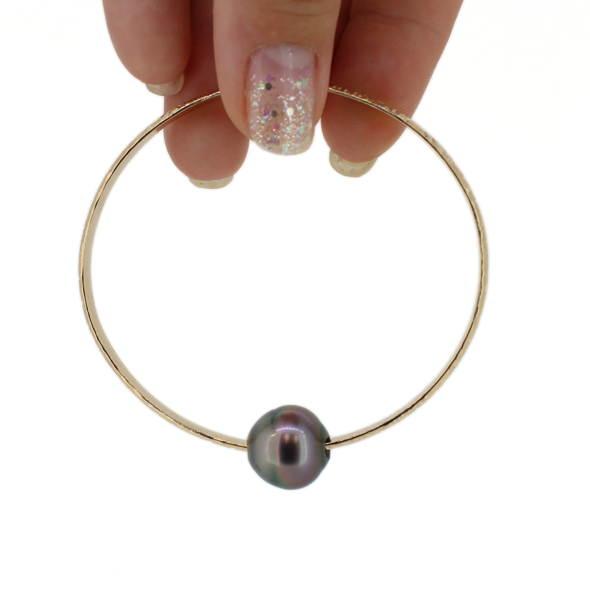 Brianne & Co. 14k gold fill oval shaped Tahitian pearl bangle bracelet shown abasing a white background