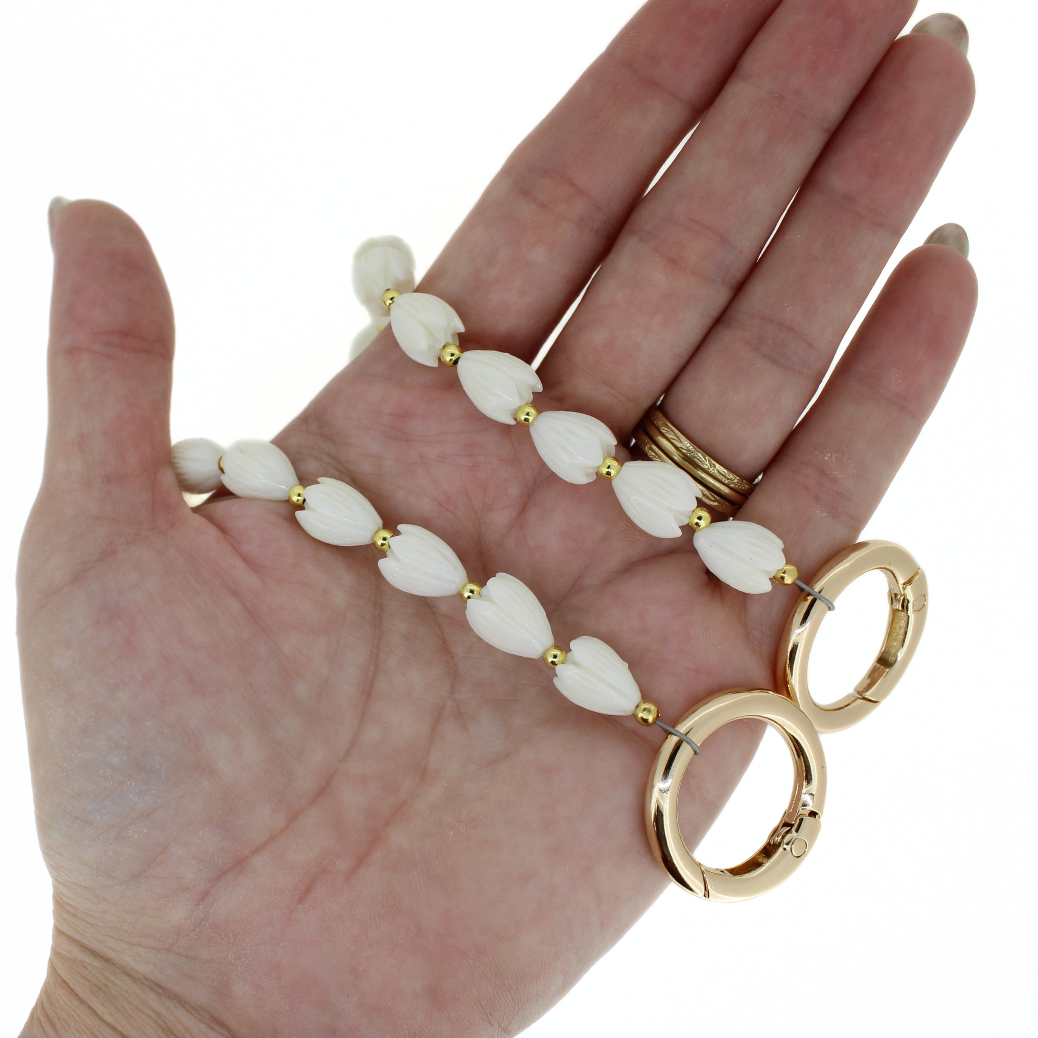 Short flower purse lei with white petal beads and gold clasp rings on a beaded chain