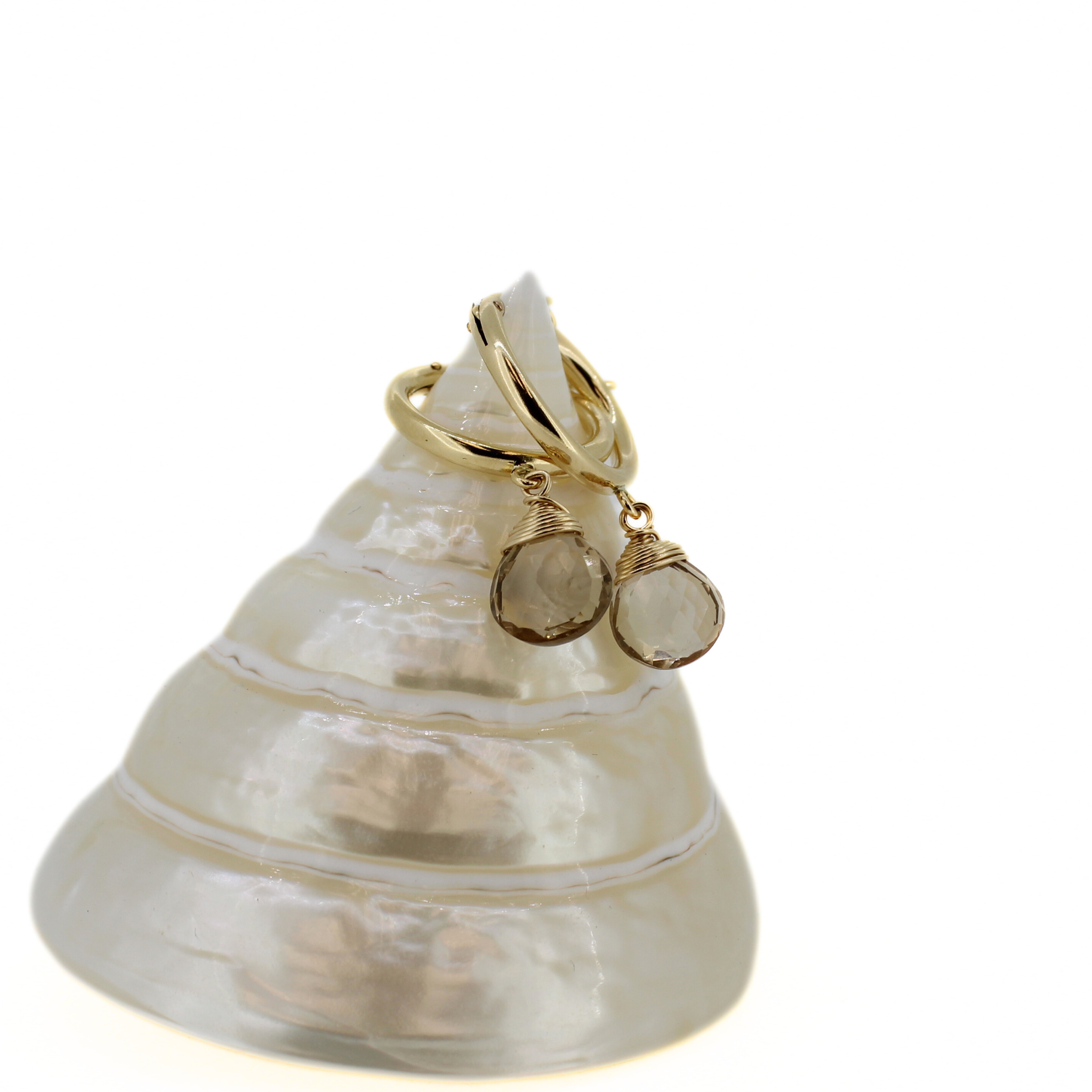Gold hoop earrings with champagne topaz dangle charms, close-up angle
