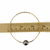 Brianne & Co gold fill bangle shown on tape measure, size 8.25 and approx 2.75" diameter