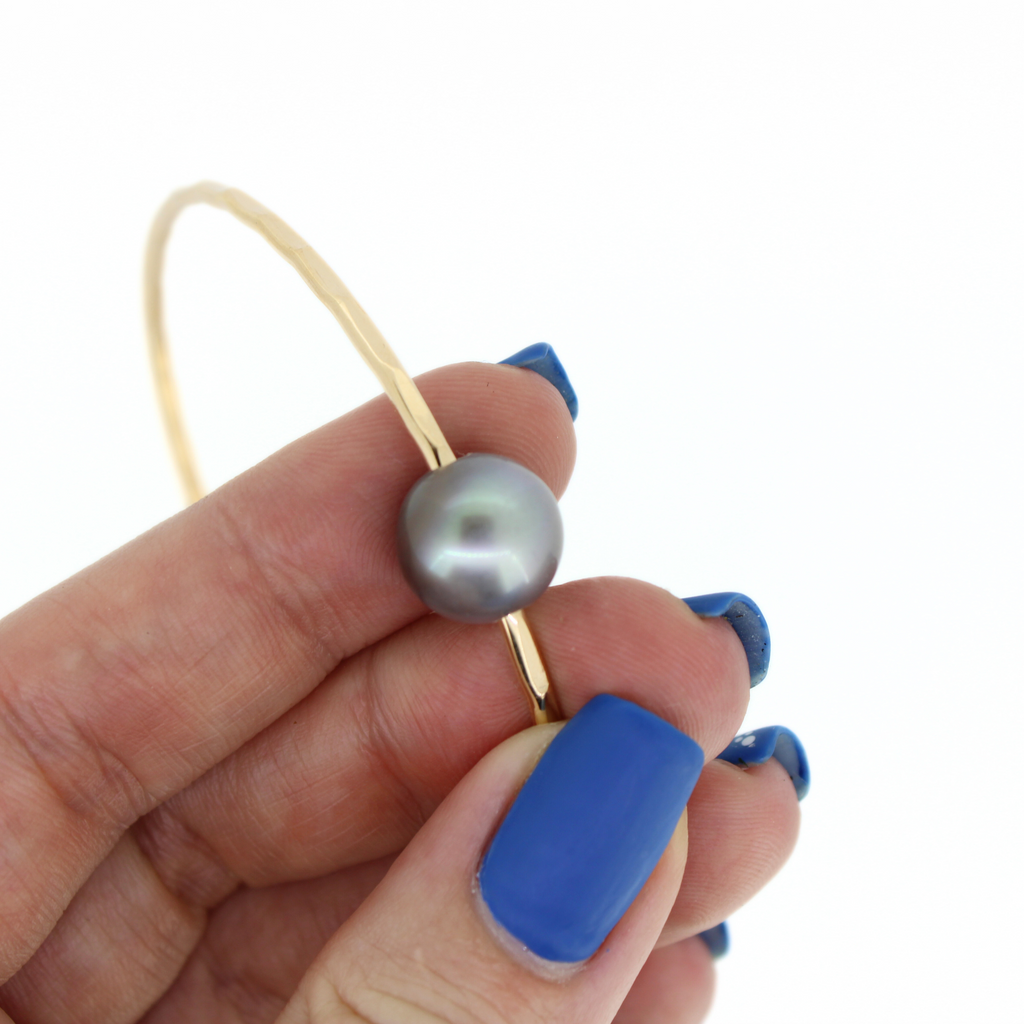 Brianne & Co gold fill bangle, close up of soft gray Tahitian pearl and hammered texture