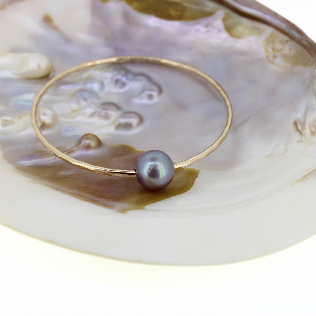 Brianne and Company gold fill hammered bangle with heather purple edison pearl, shown in shell