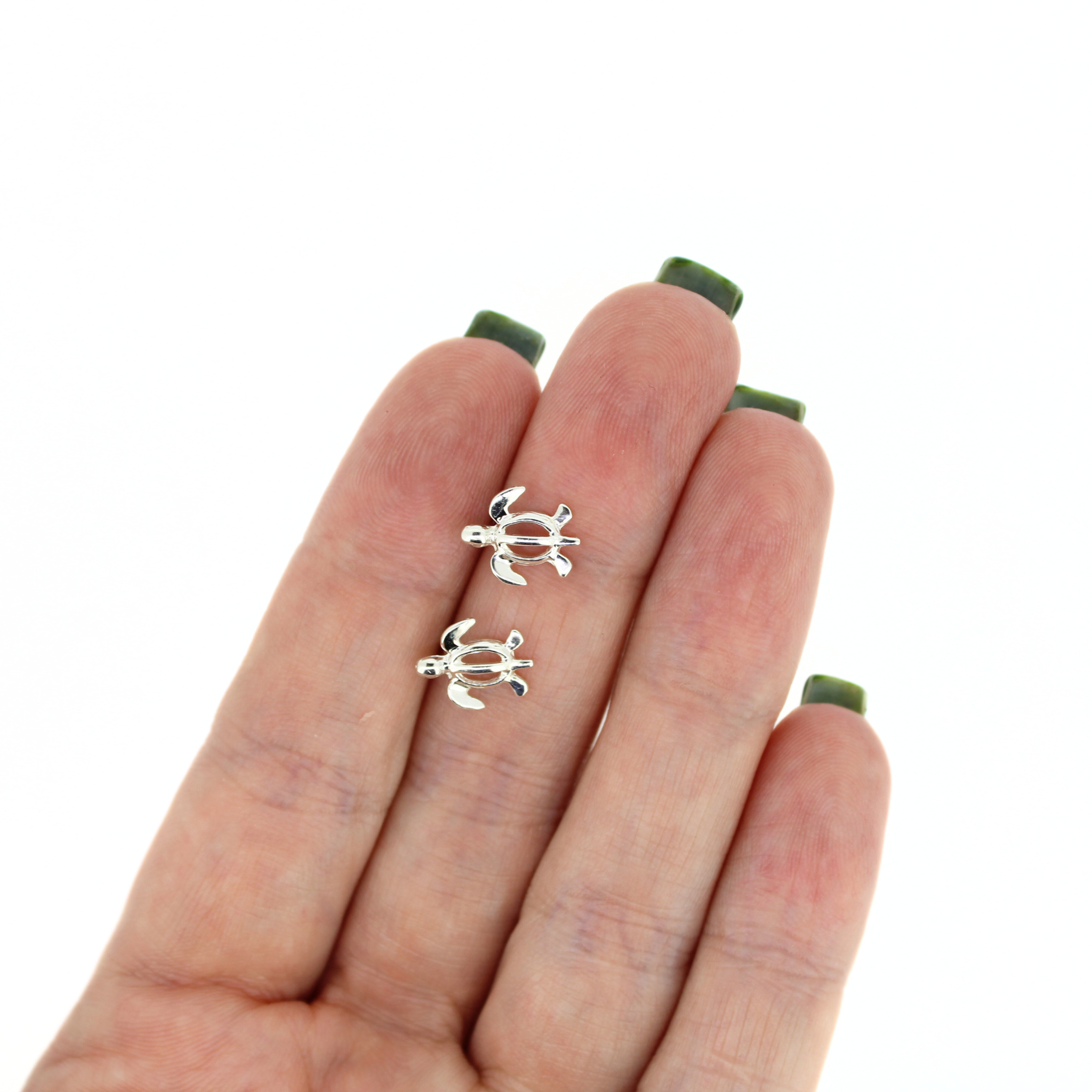Brianne & Co sterling silver sea turtle stud earrings shown in hand