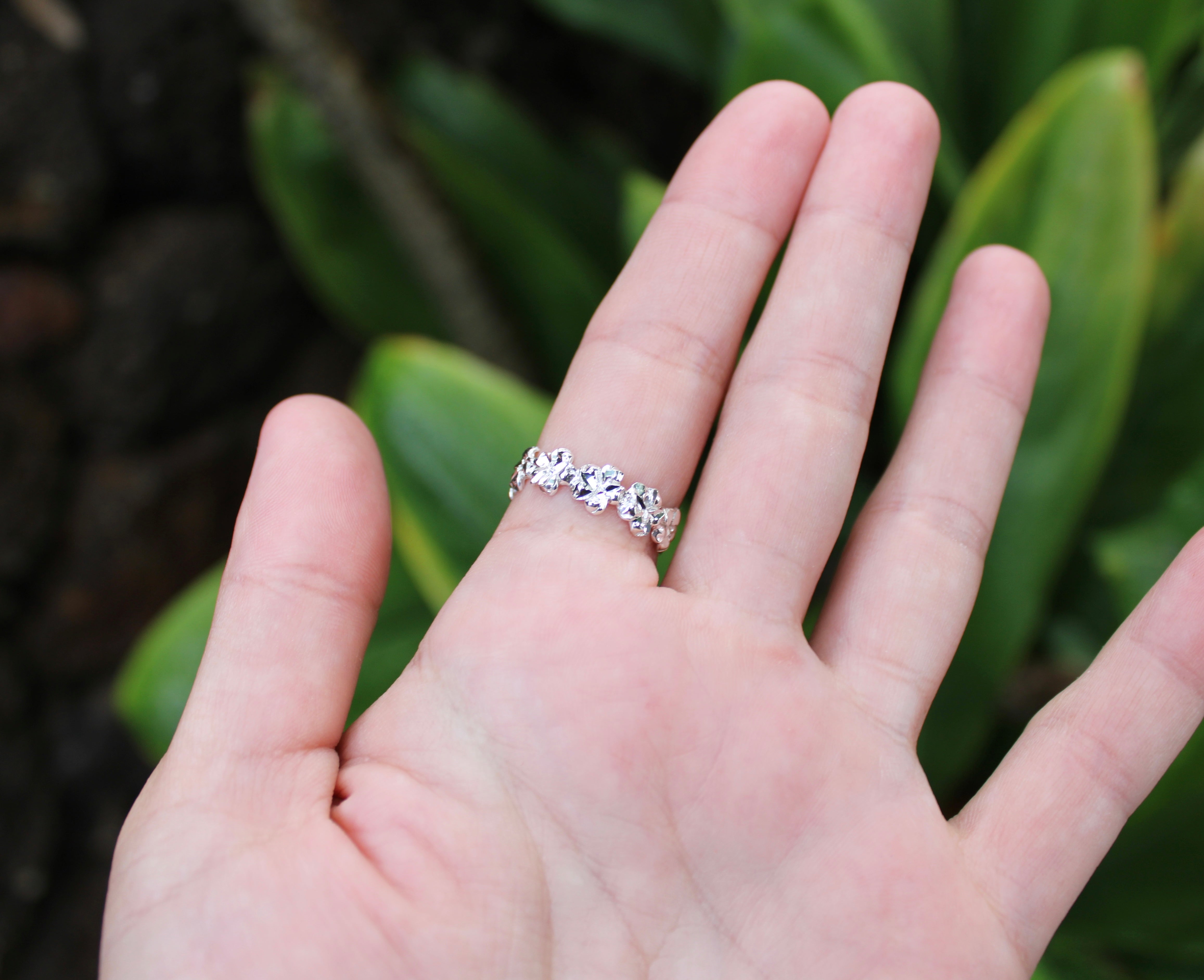 Sterling silver plumeria band ring with gemstone flower detail and pavé band