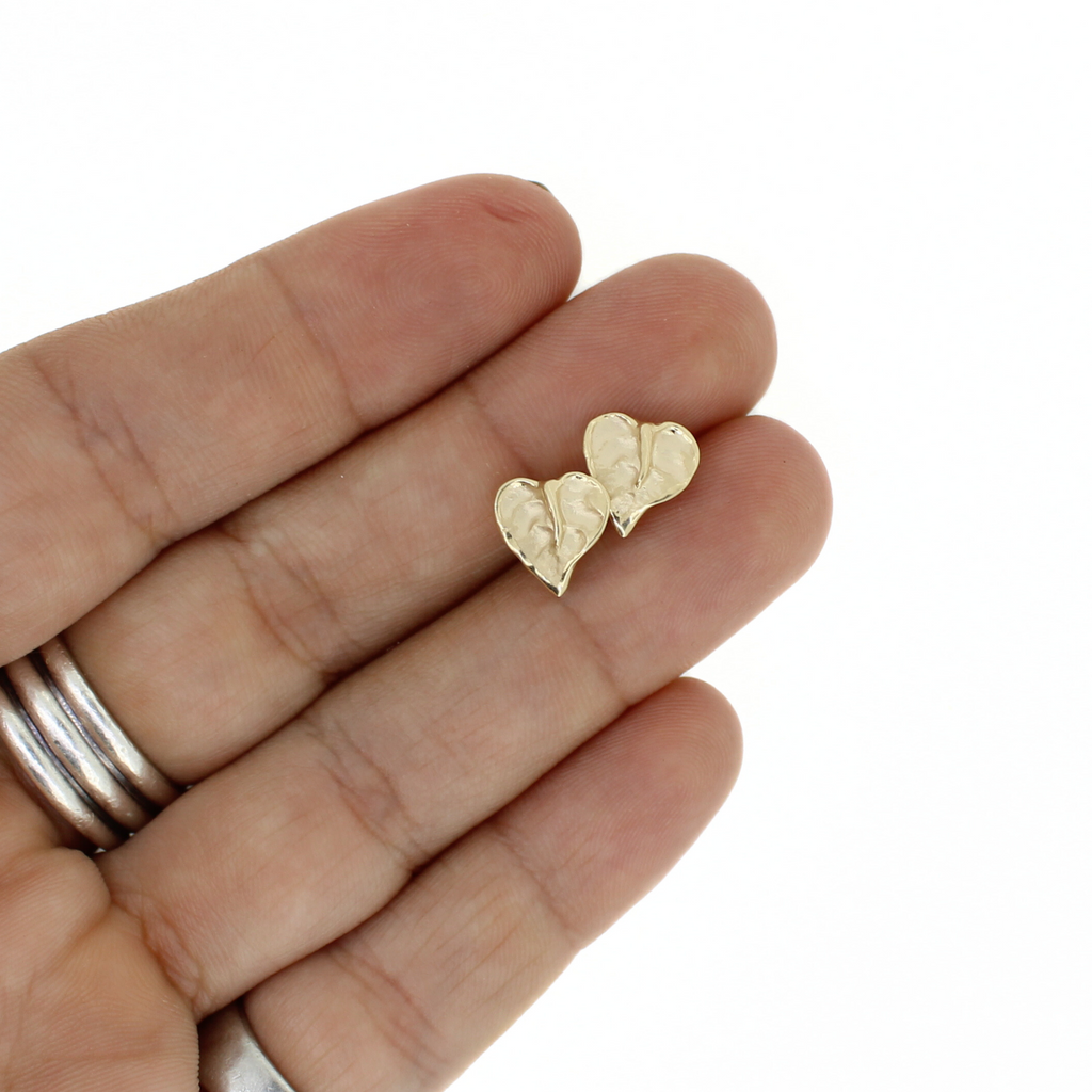 Brianne & Co. 14k gold mini anthurium flower stud earrings on hand for size reference 