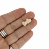 Brianne & Co. 14k gold mini anthurium flower stud earrings on hand for size reference 
