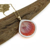 Back side of 14k gold sunrise shell necklace by Brianne & Co.