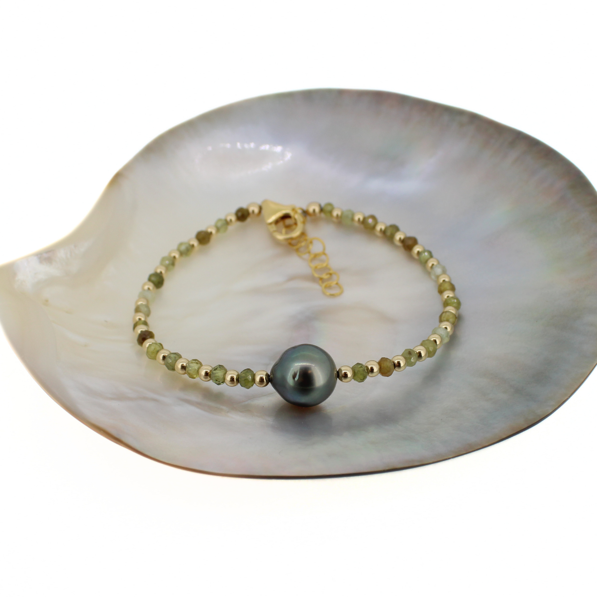 Brianne & Co. 14k gold fill bracelet with green faceted garnet gemstones and a Tahitian pearl