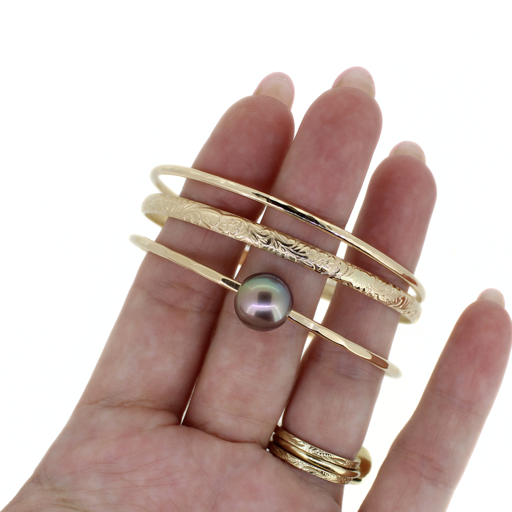 14k gold fill triple bangle set featuring a delicate hammered bangle, our popular floral bangle, and a stunning deep purple Edison pearl bangle. Handmade by Brianne & Co.