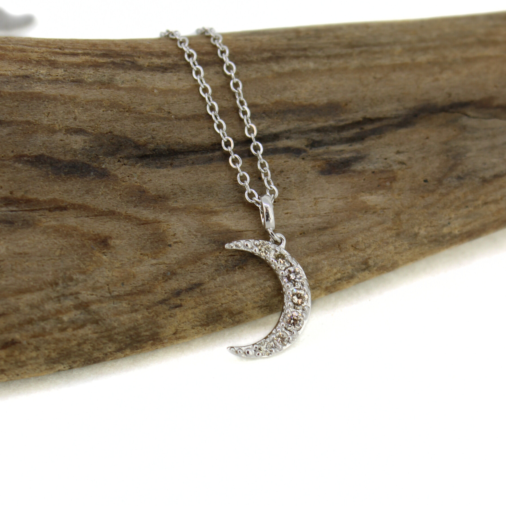 Brianne & Co. 14k white gold diamond moon necklace close up with 7 tiny diamonds
