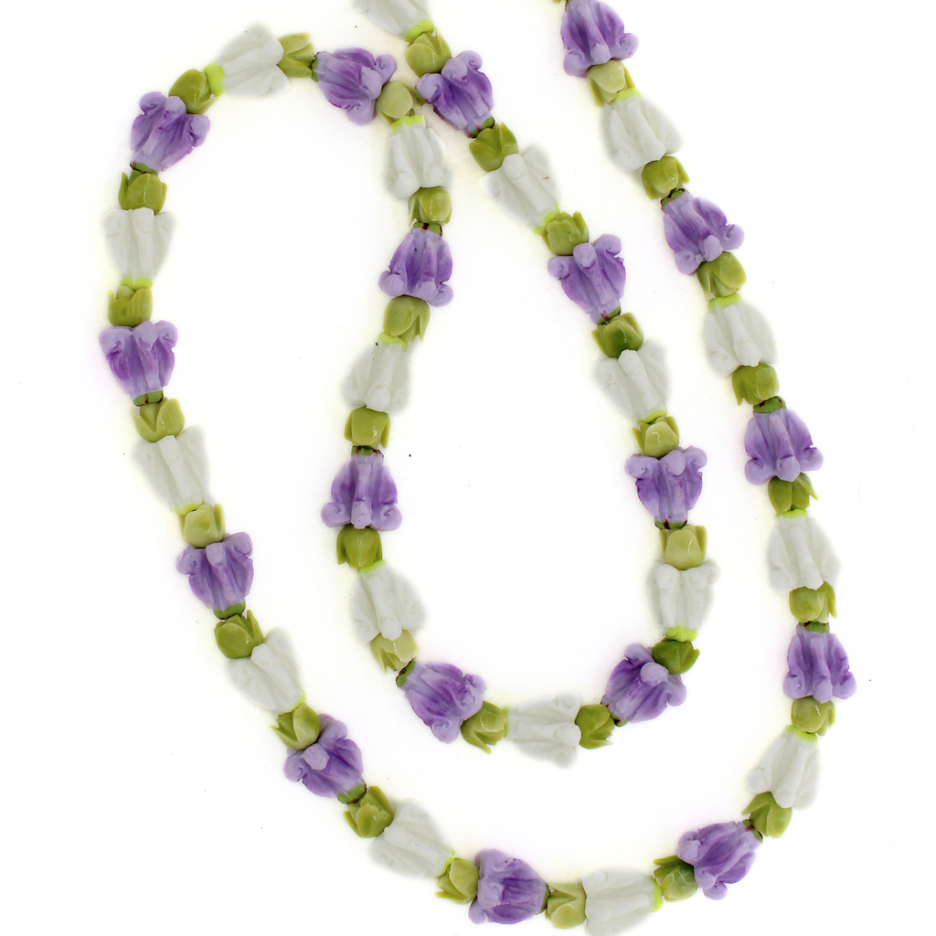 Brianne & Co. long purse lei featuring purple and white crown flowers and green pakalana flowers