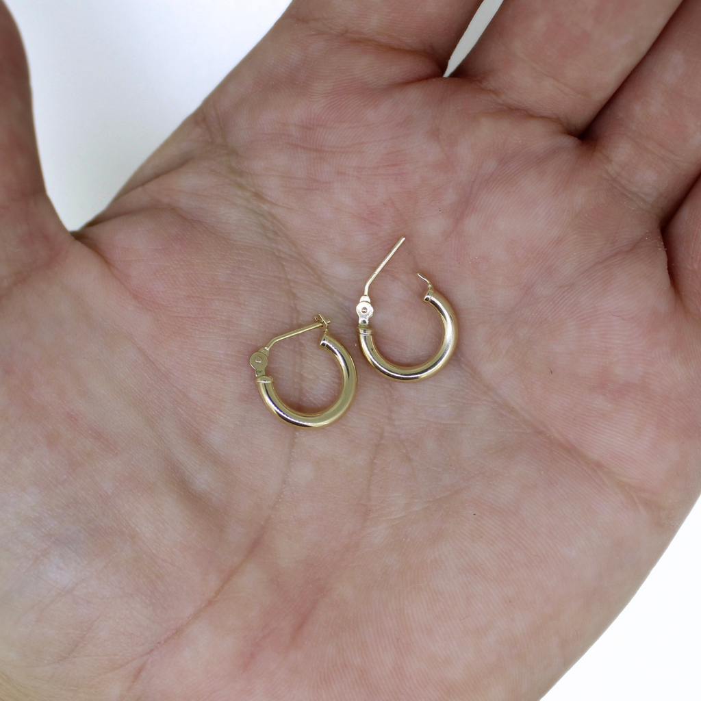 Brianne & Co. 14k gold 12mm hoops on palm of hand