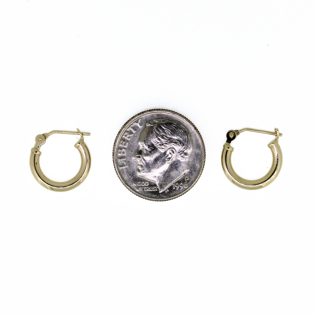 Brianne & Co. 14k yellow gold 12mm hoop earrings next to US dime for size reference