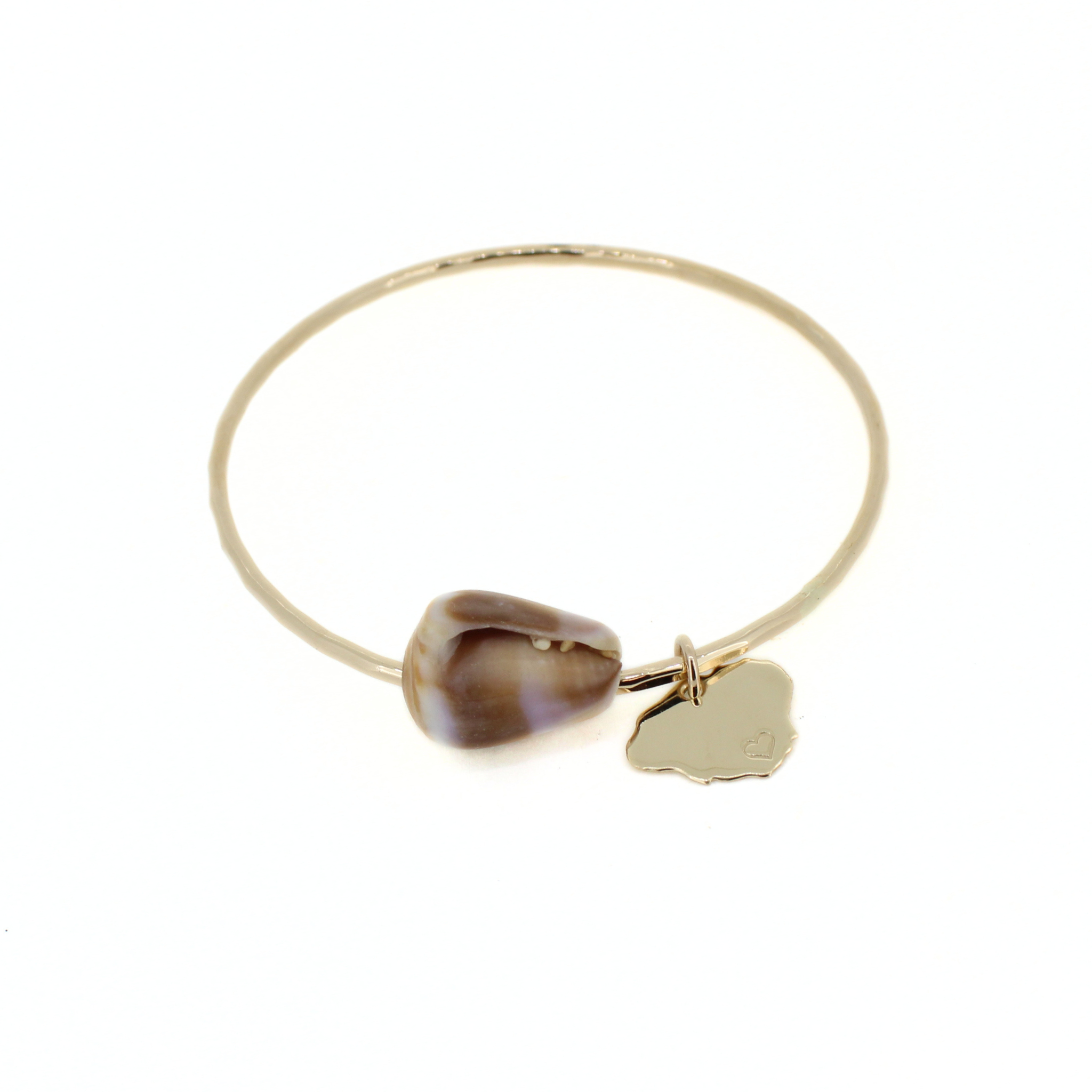 Brianne & Co. 14k gold fill bangle bracelet featuring a natural Hawaiian cone shell and a Kauai island charm