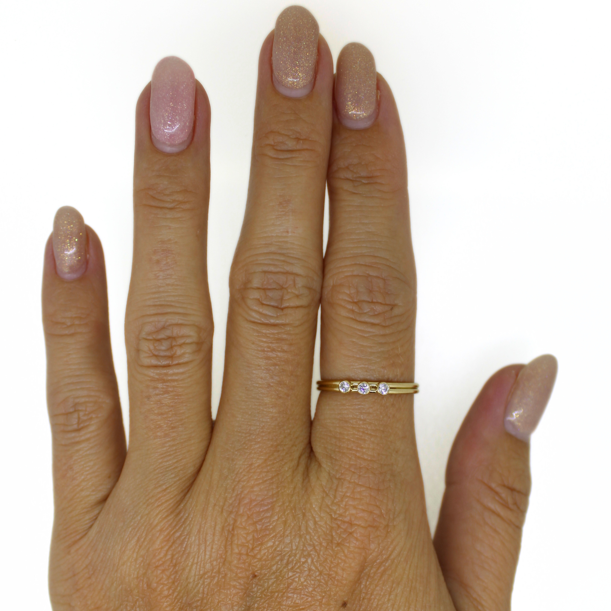 Brianne & Co. 14k gold filled triple CZ ring on hand for size reference