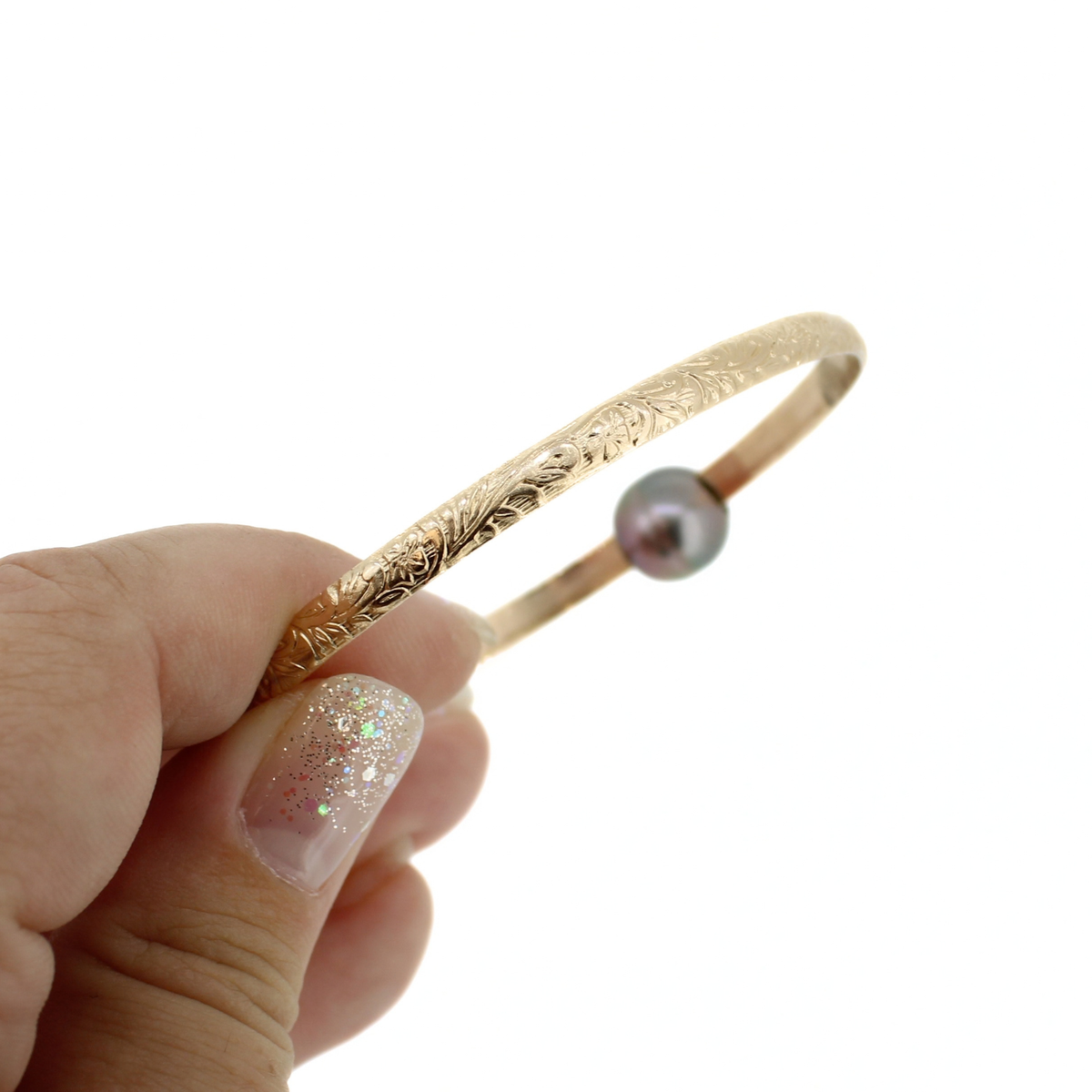 Gold floral printed bangle bracelet shown against a white background 