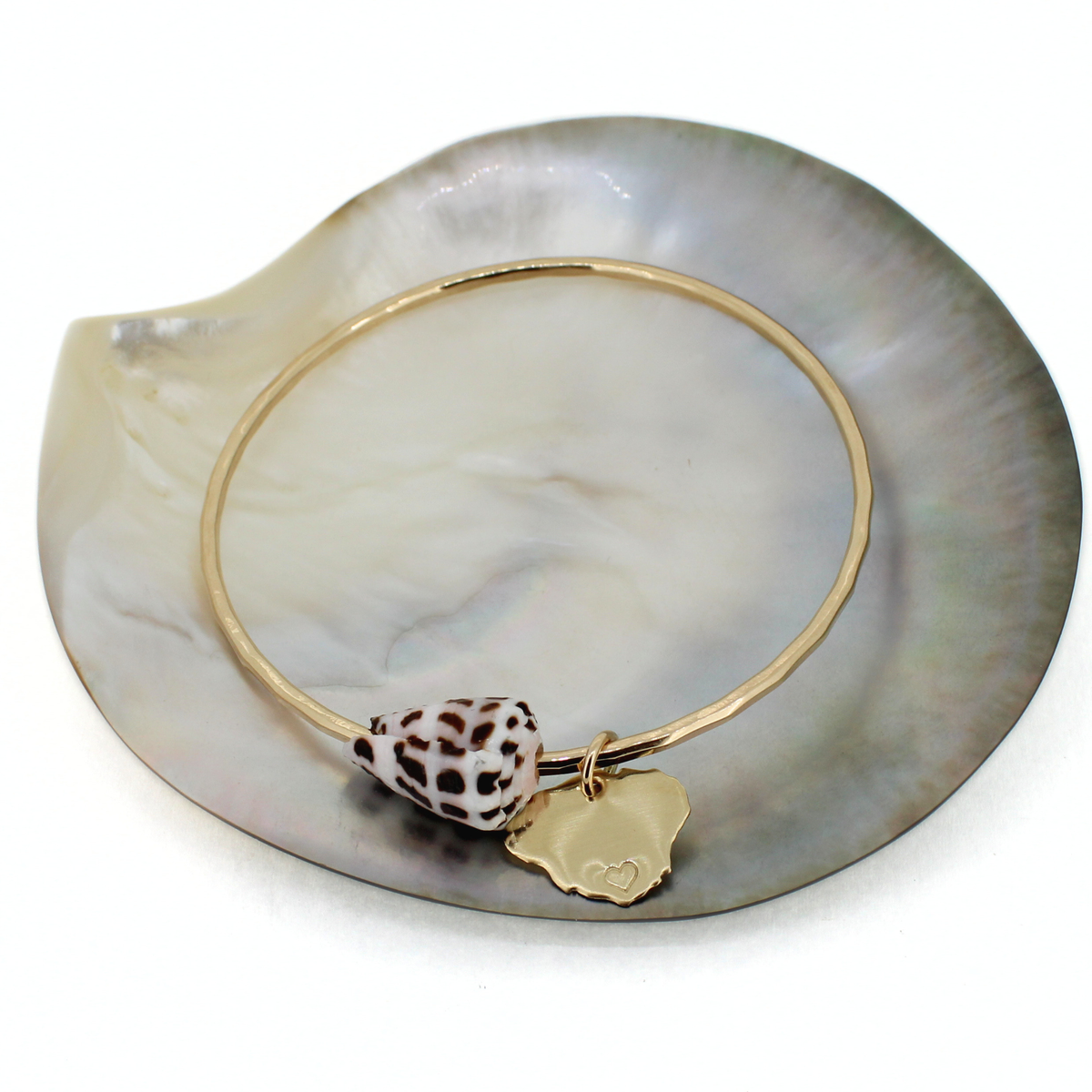 Brianne & Co. 14k gold fill bangle bracelet featuring a genuine Hebrew cone shell and a Kauai island charm with a heart on the south side of the island
