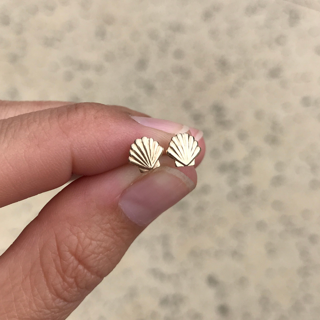 Brianne & Co. tiny gold fill shell stud earrings on hand for size reference