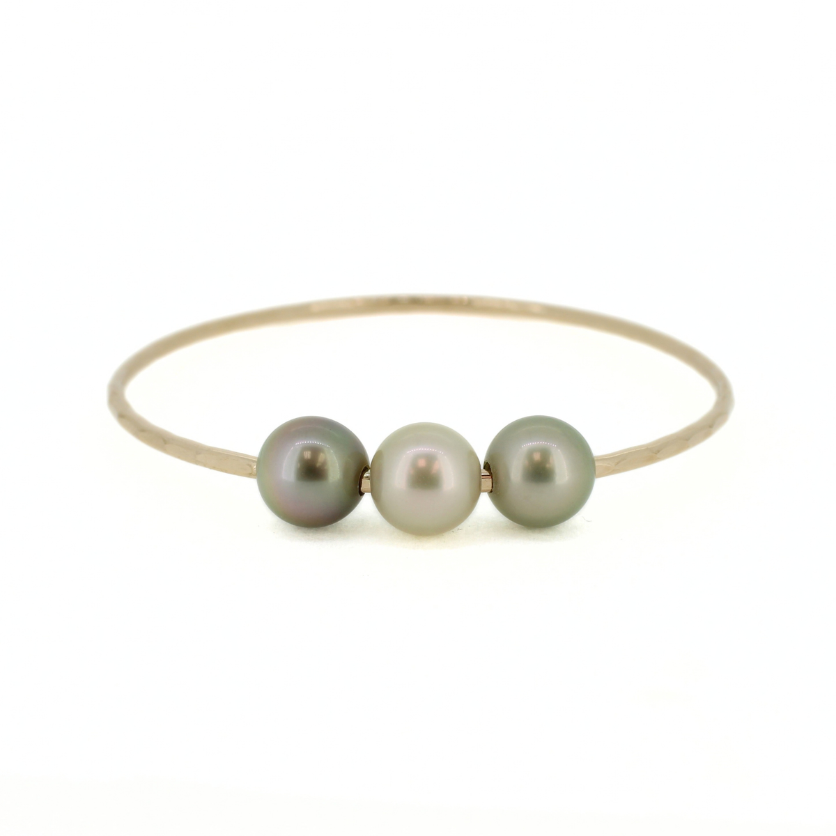 A thin gold bangle bracelet featuring three small, round, iridescent pearls in muted green-gray tones, set against a plain white background.