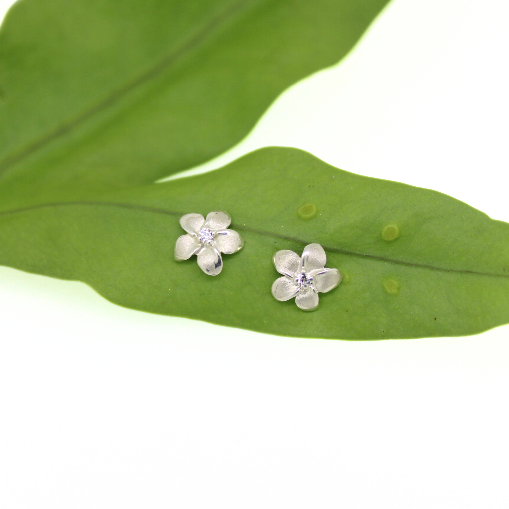 Brianne & Co. sterling silver small plumeria stud earrings with cubic zirconia