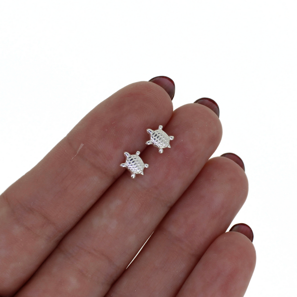 Brianne & Co. sterling silver tiny honu turtle stud earrings n hand for size reference