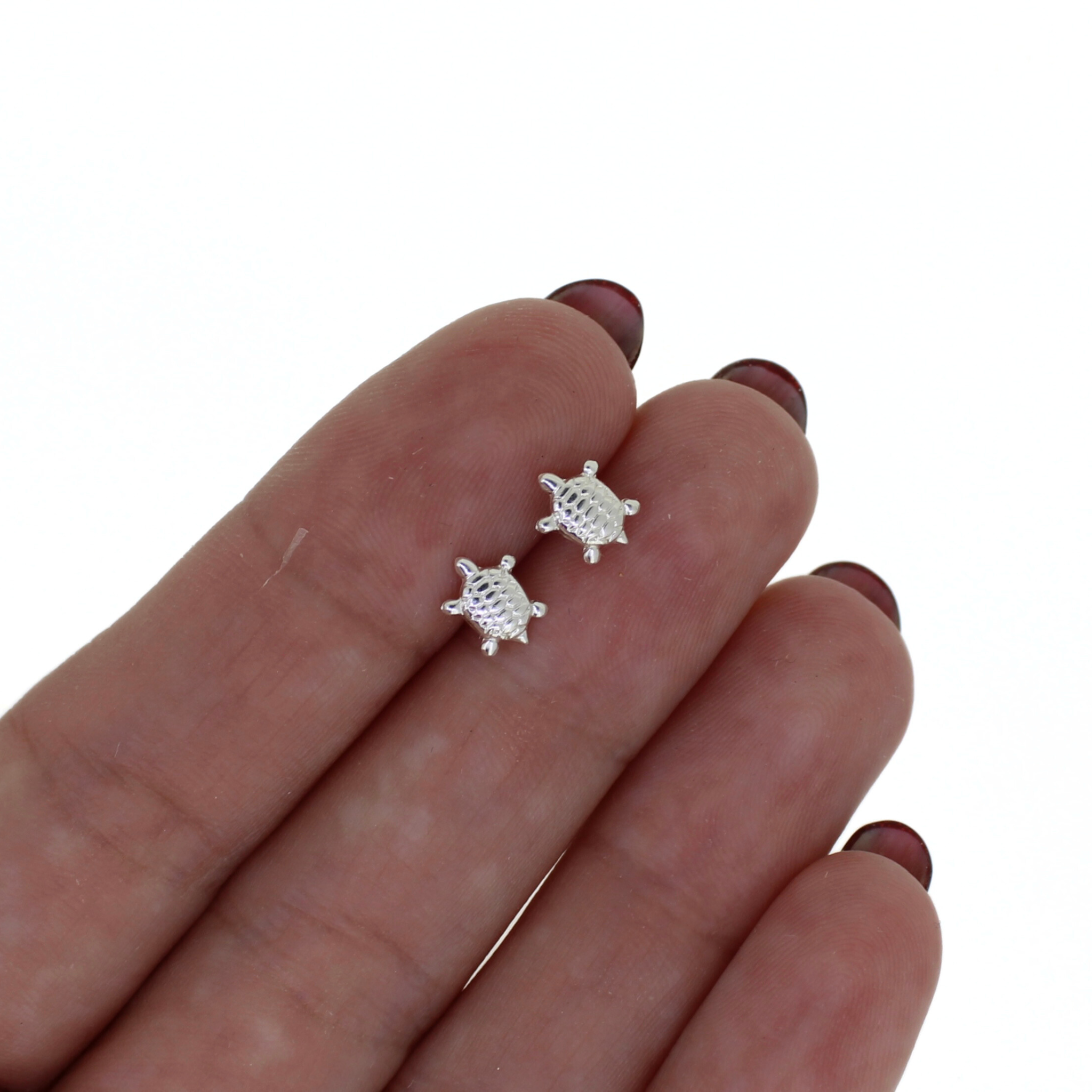 Brianne & Co. sterling silver tiny honu turtle stud earrings n hand for size reference