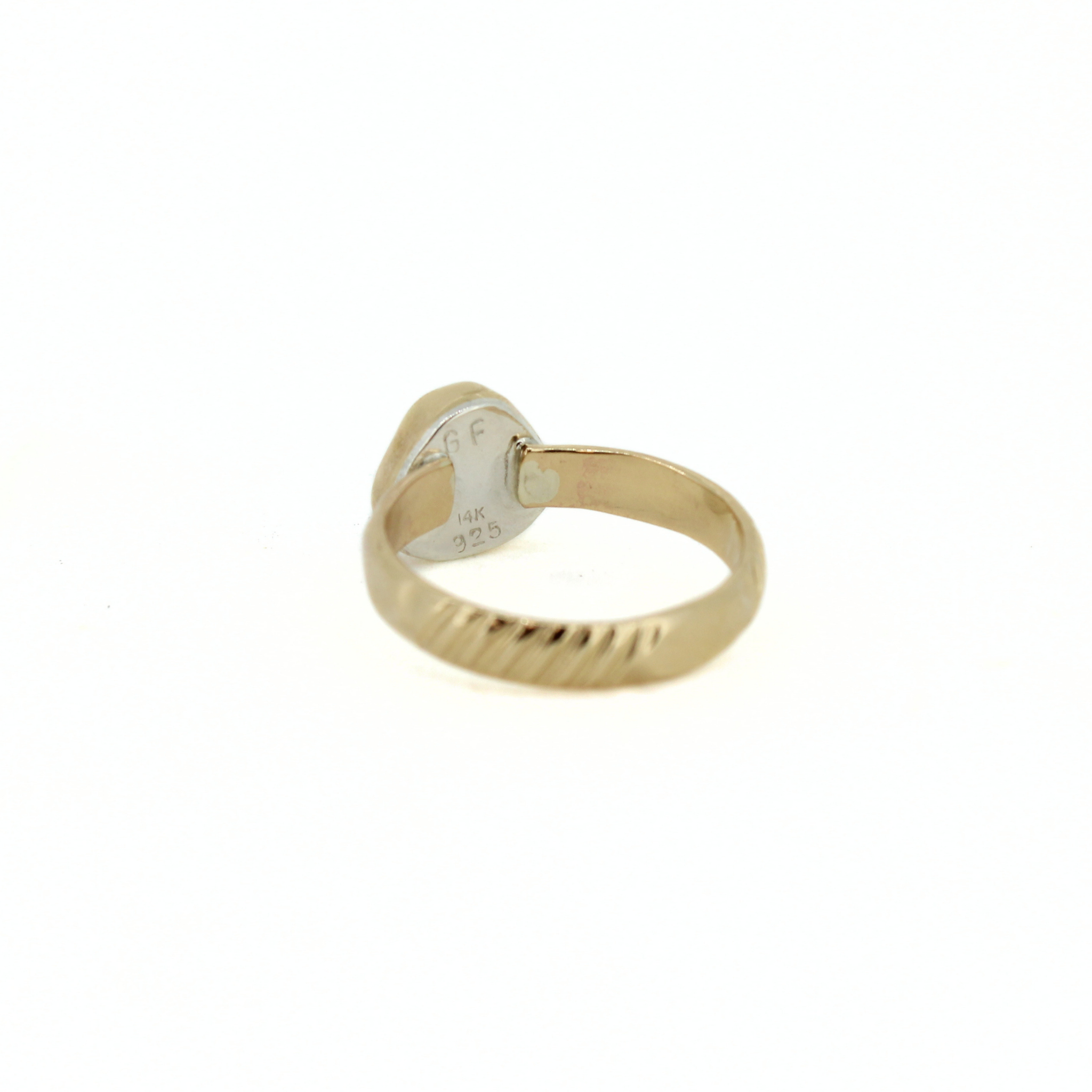 Inside view of gold ring showing stamp and band interior