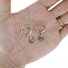 Brianne & Co. gold fill 15mm hoop earrings with rutile quartz on hand for size reference