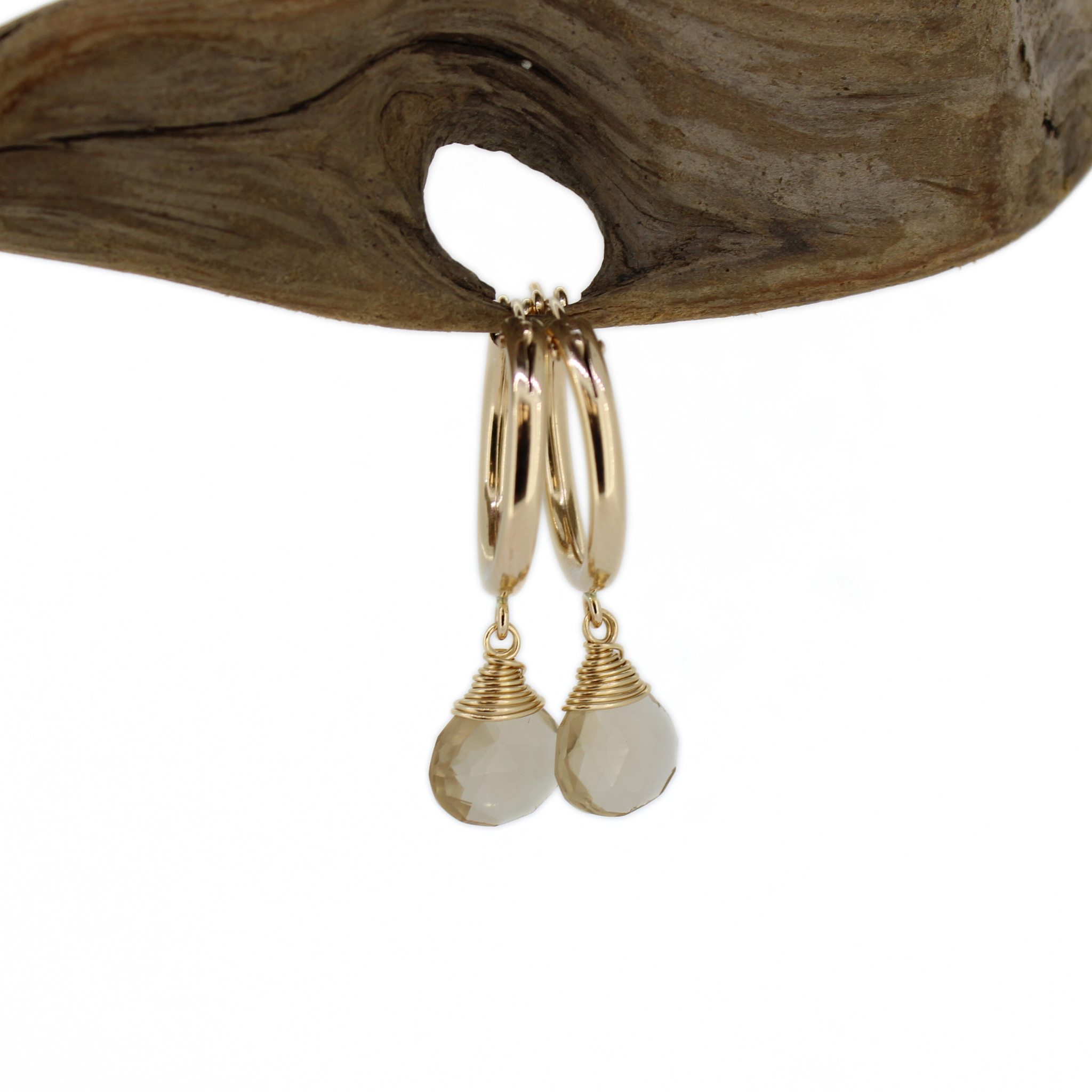Gold hoop earrings with champagne topaz dangle charms, hanging front view