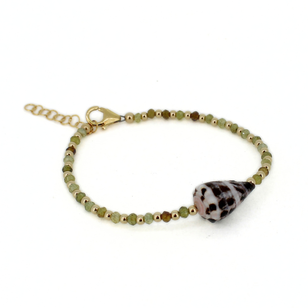 A delicate beaded bracelet with small green and brown beads, a gold clasp, and a genuine Hebrew cone shell, shown on a plain white background.