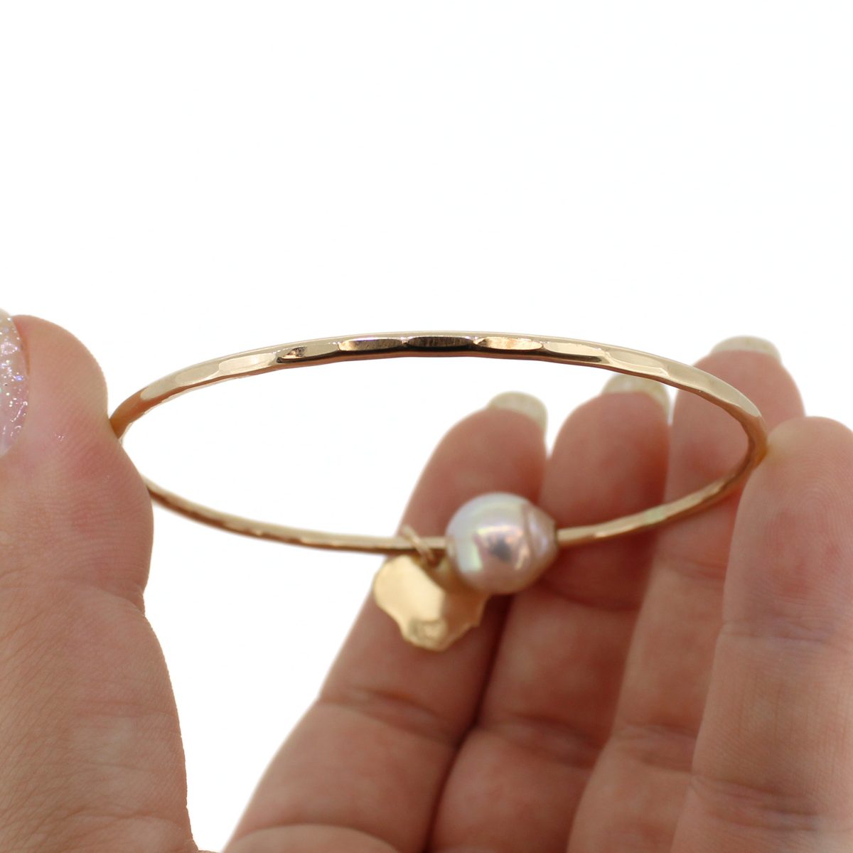 Gold bangle bracelet with a hammered texture