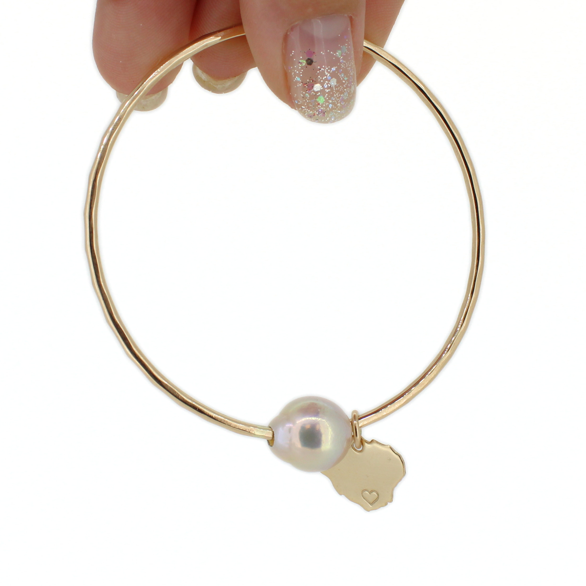 Gold round bangle bracelet with a white baroque pearl and Kauai island charm with a heart on the south side of the island shown against a white background 