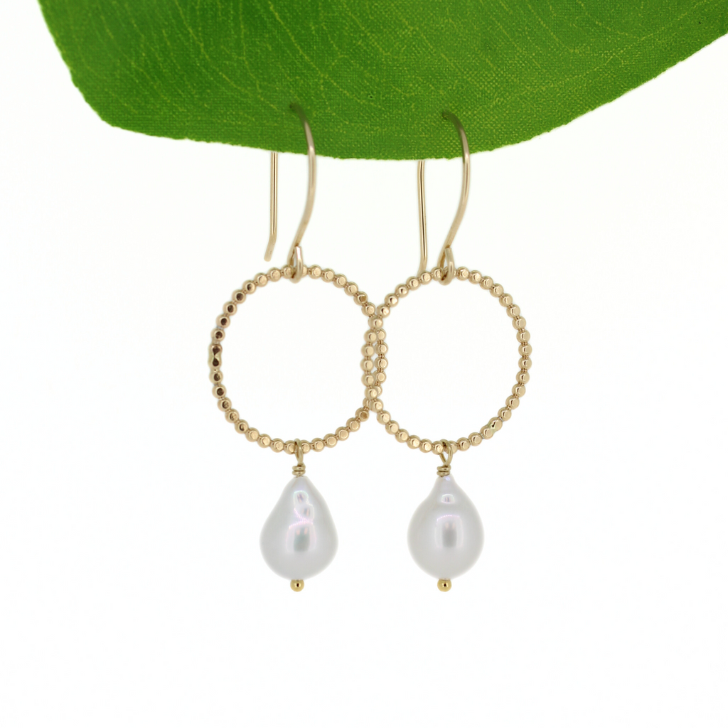Gold hoop earrings with pearl drops on a white background handmade by Brianne & Co.