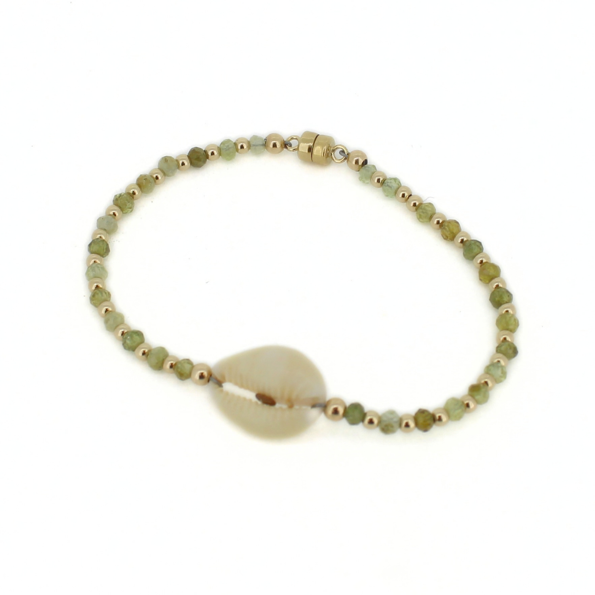 A beaded bracelet featuring light green faceted beads, small metallic gold spacer beads, and a central natural cowrie shell, displayed on a clean white background.