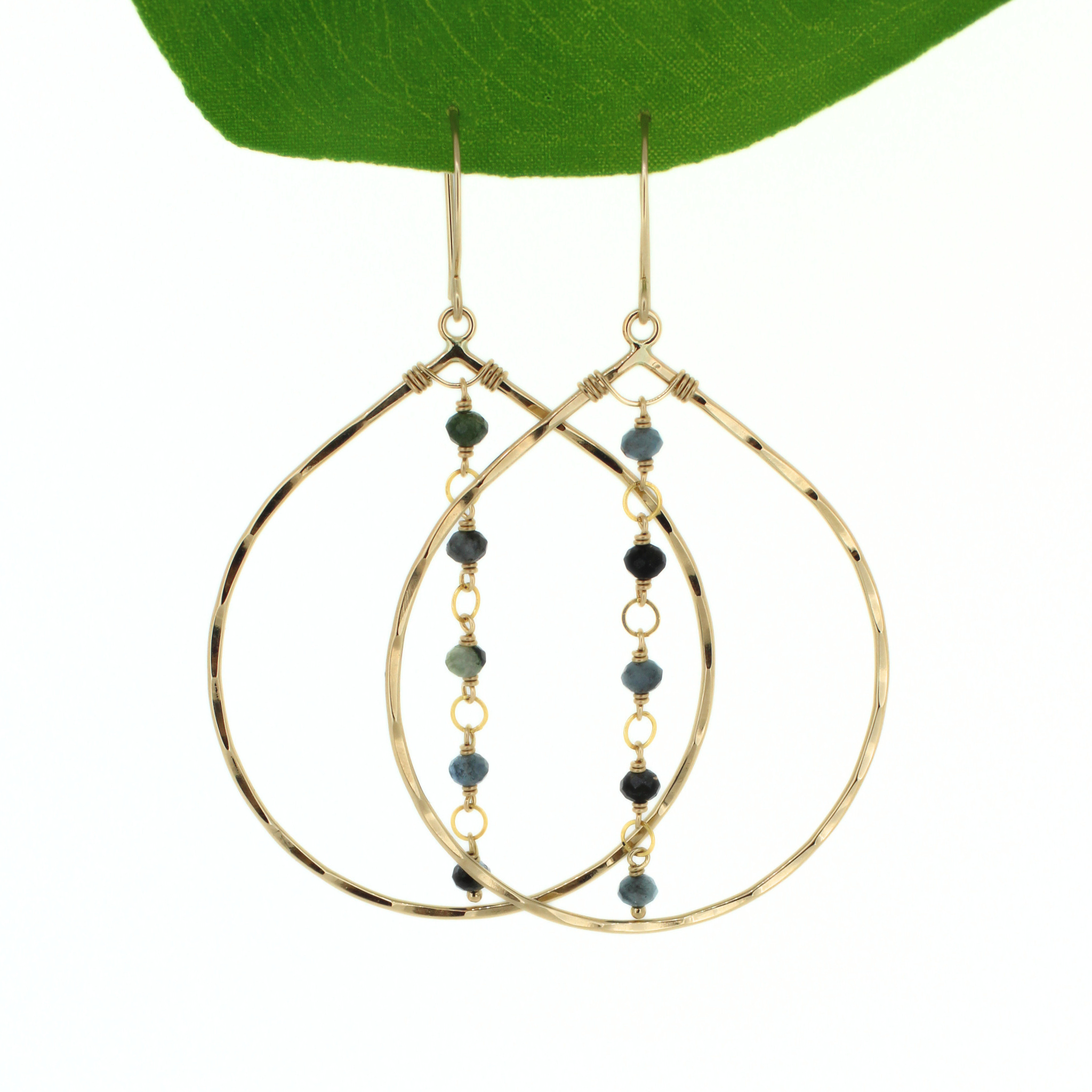 Brianne & Co. 14k gold fill tear drop hoop earrings featuring dark blue faceted aquamarine gemstones
