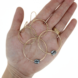 Brianne & Co. gold fill double hoop earring with Tahitian keshi pearls on hand for size reference