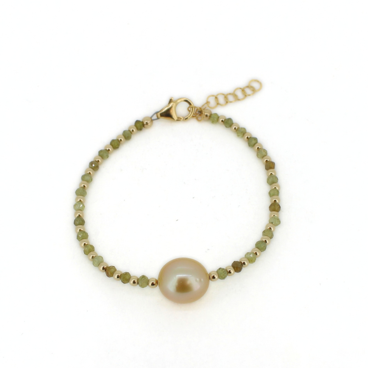 A delicate gold bracelet featuring a central round pearl and small faceted green beads, displayed on a clean white background.