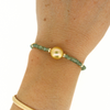 Brianne & Co. gold fill golden south sea pearl and green apatite gemstone bracelet  on wrist for size reference